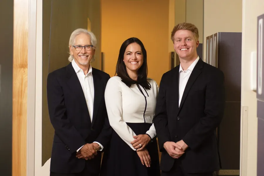 Drs. Gallagher, Gonzales and Krohnfeldt standing together in a doorway, photographed in 2020.