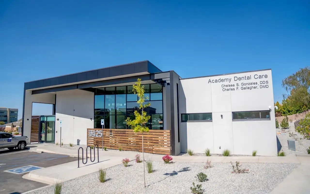 The Academy Dental Care building at 6425 Holly Ave NE, Albuquerque, with its name on the facade and timber slats along the front.